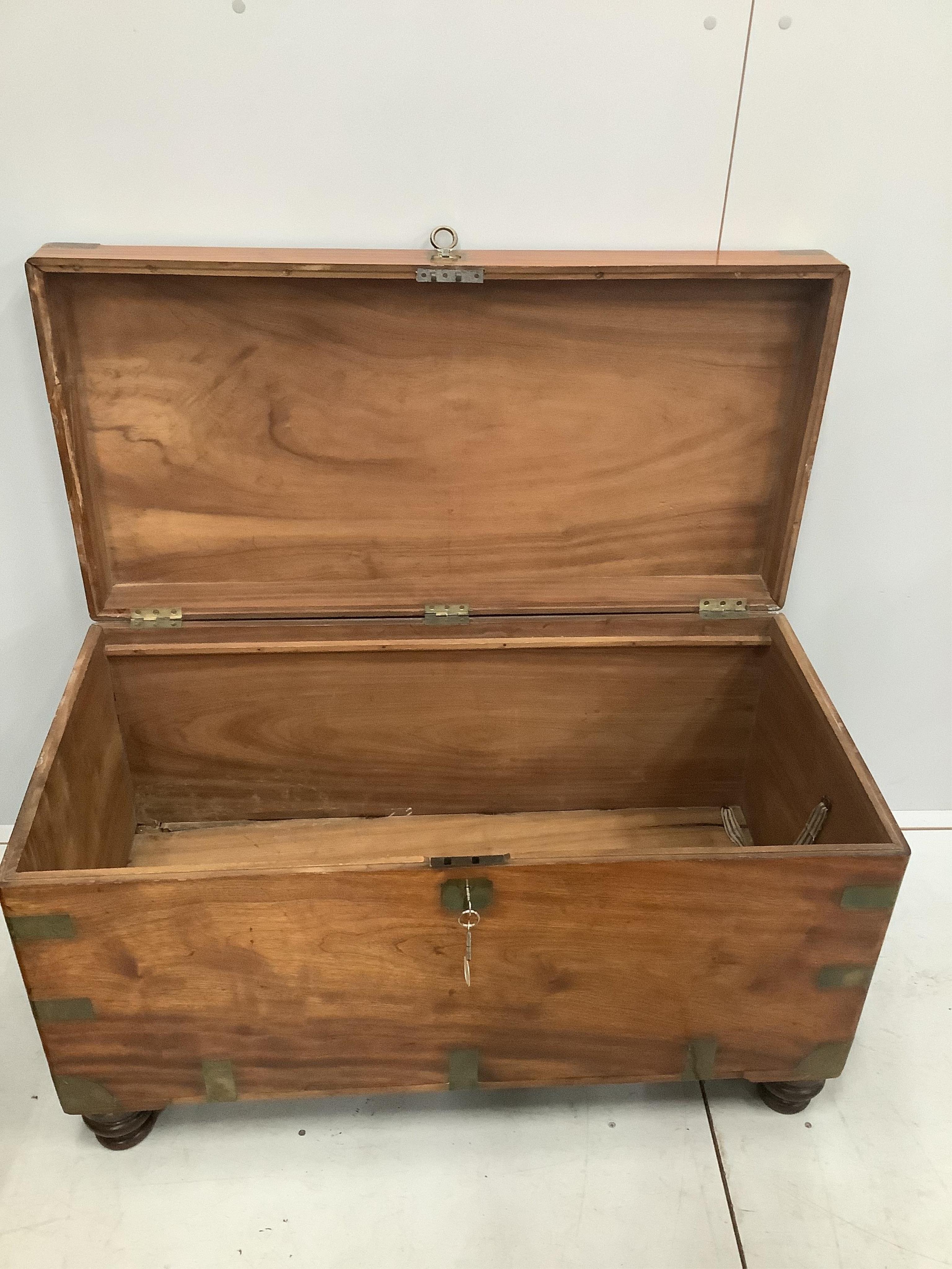 A 19th century camphorwood and brass bound campaign chest, with internal trays, on turned feet, width 106cm, height 64cm. Condition - good